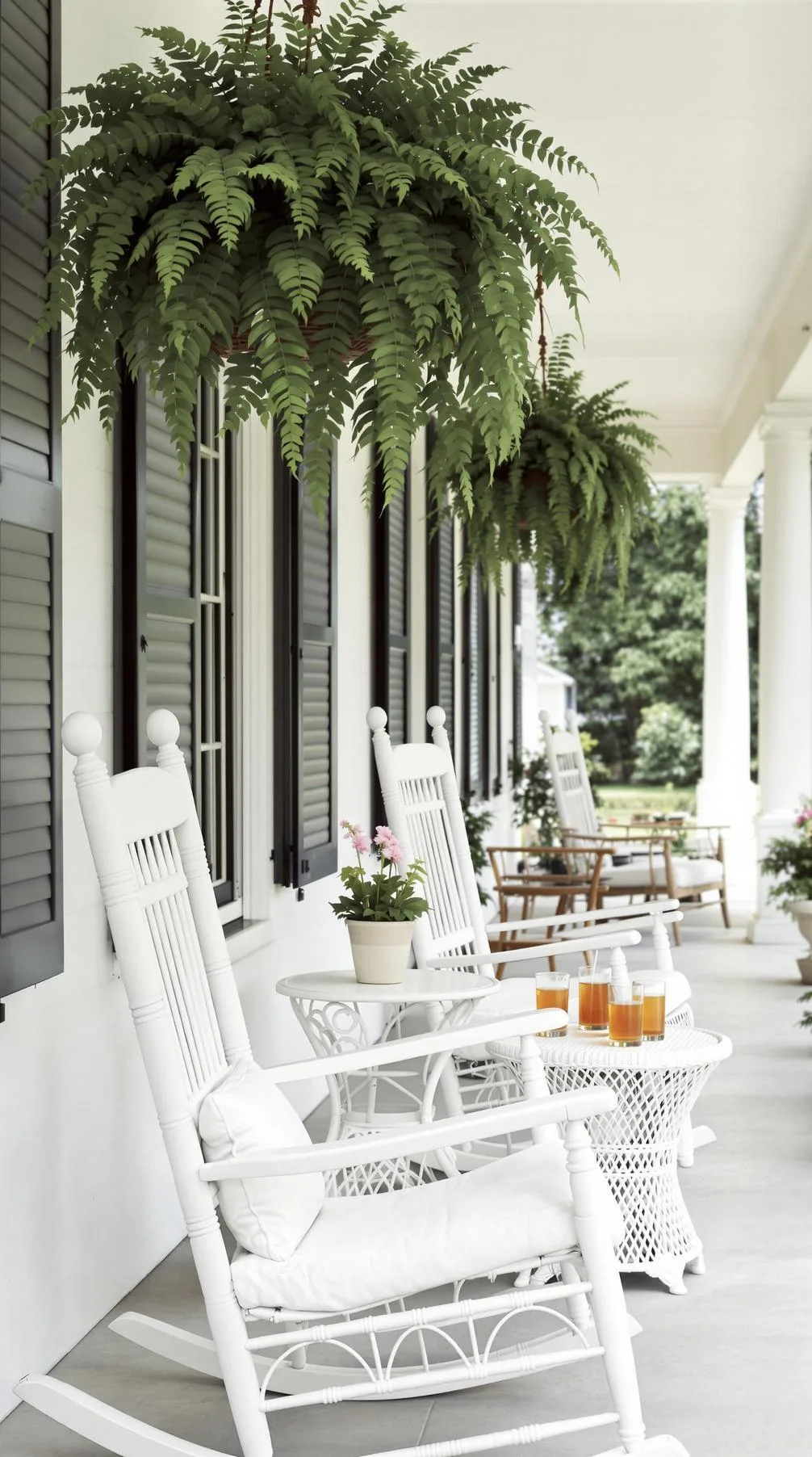 12. Classic Southern grace employing rocking chairs, hanging ferns, and white wicker-0 12. Classic Southern grace employing rocking chairs, hanging ferns, and white wicker-0