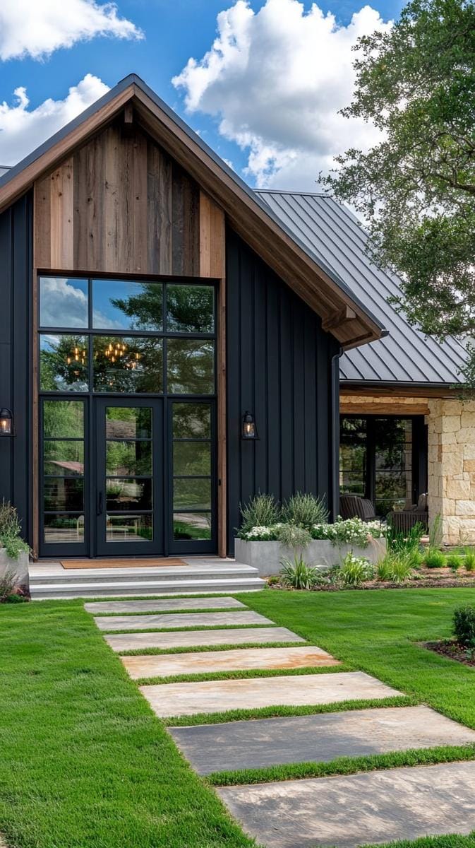 black metal siding with reclaimed wood accents and oversized industrial glass doors 1