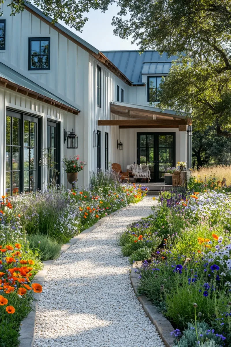 colorful wildflower garden lining a gravel pathway to the entrance 1