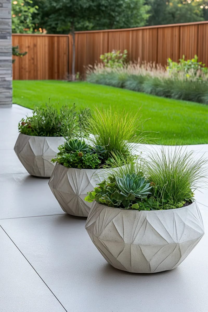 15 Unique Concrete Backyard Ideas for Creative Outdoor Style 7 sculptural concrete planters clustered for a minimalist backyard focal point 1