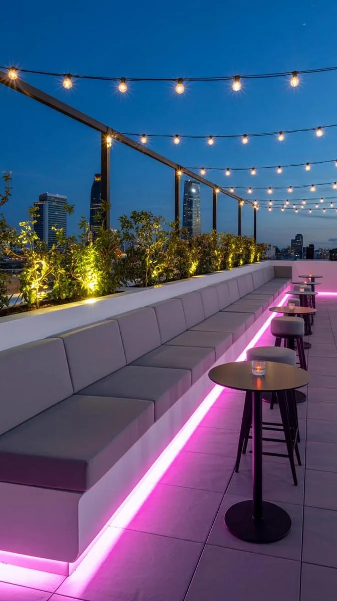 sleek rooftop bar with built-in seating and led underlighting 1