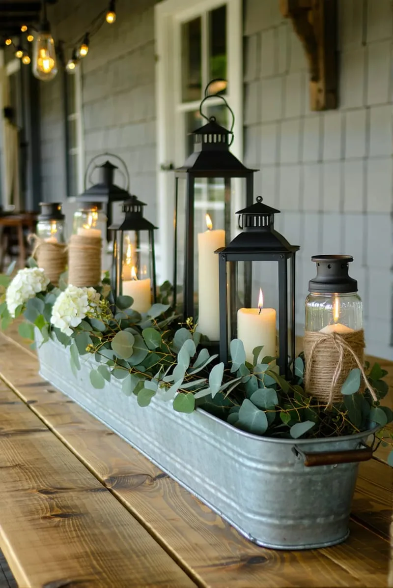 candlelit lanterns scattered across a galvanized trough centerpiece 1