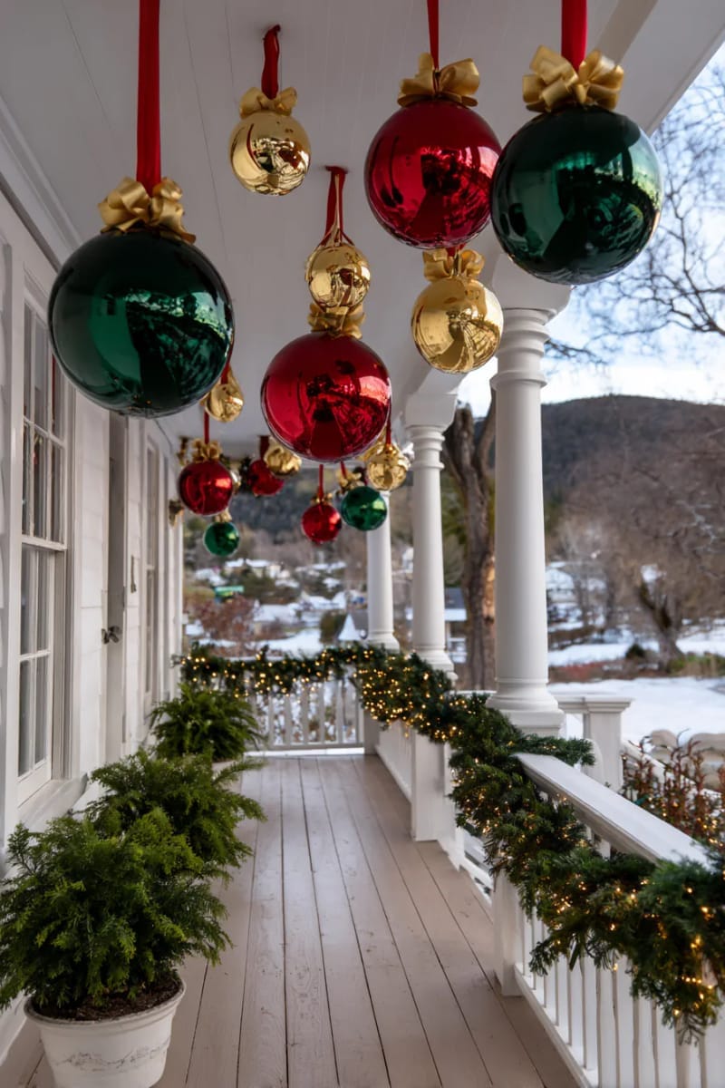 31 Outdoor Christmas Decorations: Ideas for a Magical Welcome 14 cascading oversized baubles and ribbons from porch ceilings 1