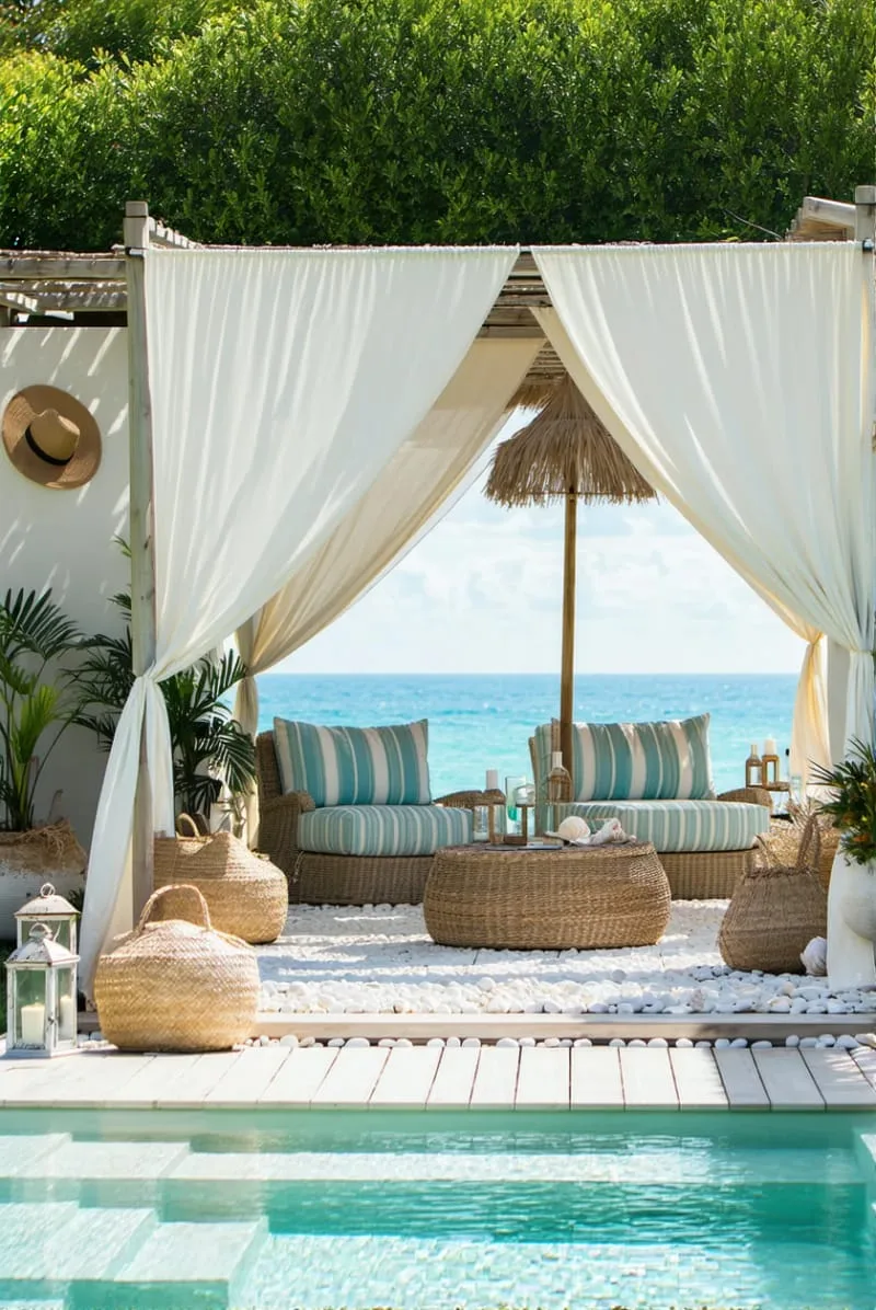 coastal chic cabana with linen curtains overlooking the pool 1