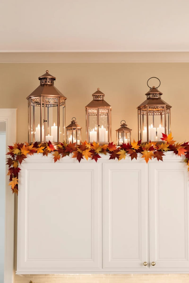 copper lanterns styled above cabinets adding warmth in autumn 12