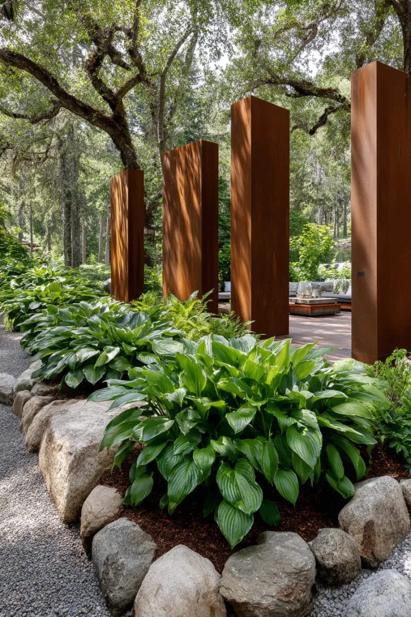 27 Unique Backyard Privacy Designs for A Serene Outdoor Oasis 80 corten steel partitions paired with lush hosta plantings 1