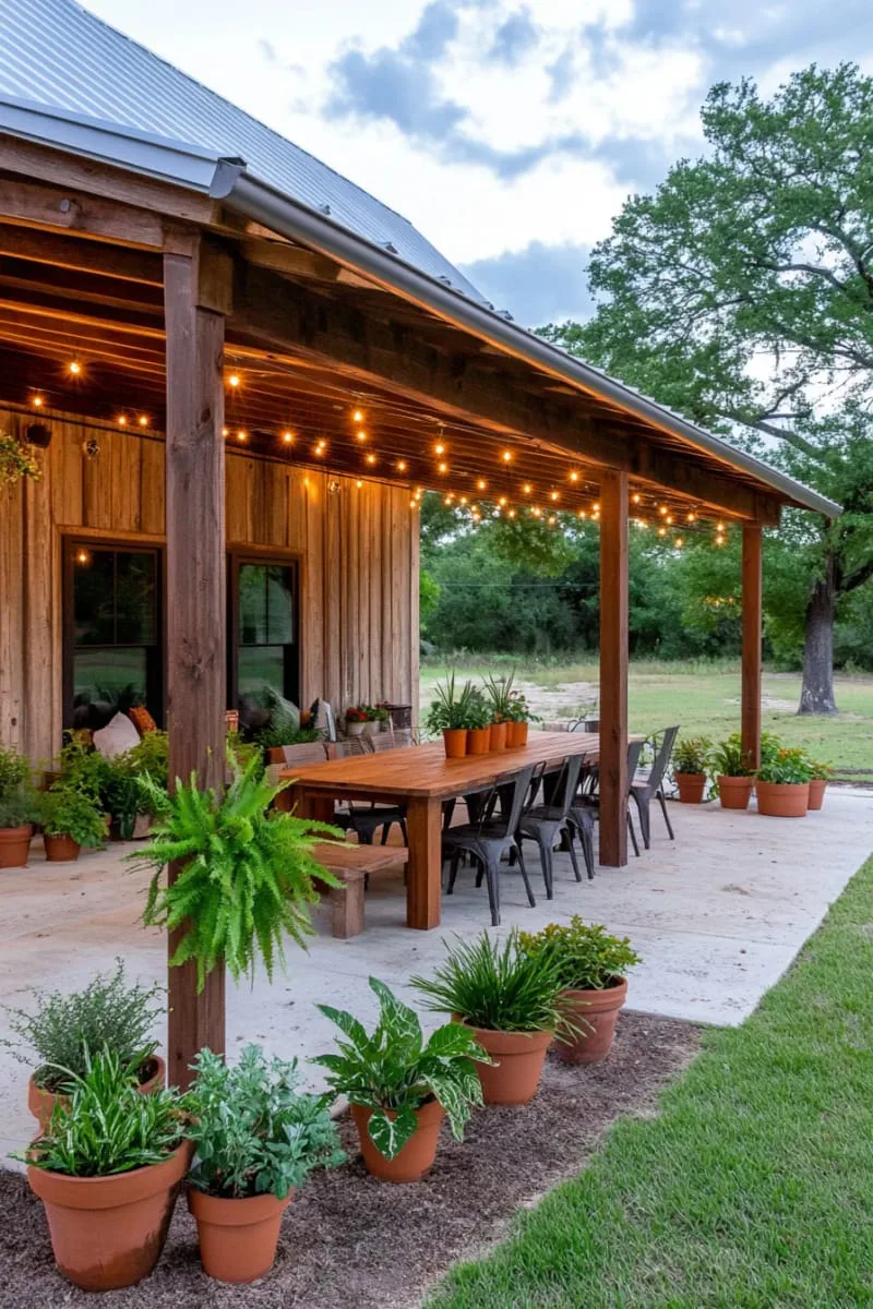cozy barndominium with covered outdoor dining area and potted plants 1