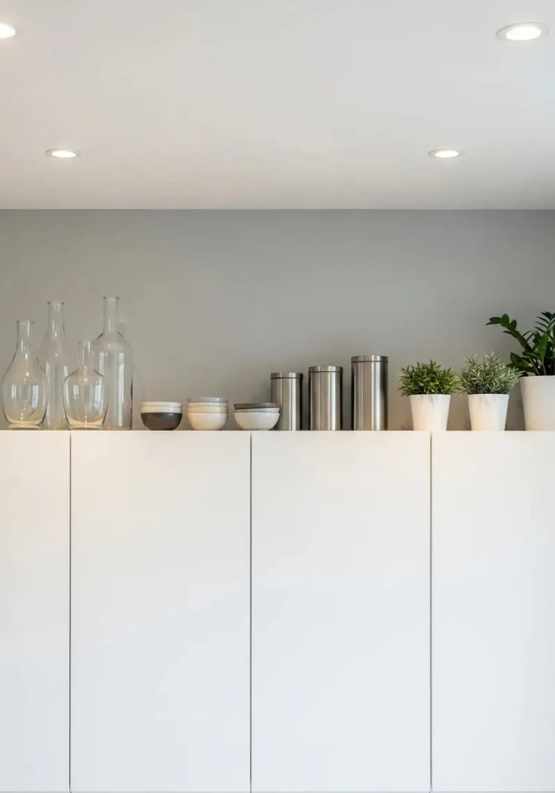 easy-to-clean decorative pieces placed thoughtfully above kitchen cabinets 1