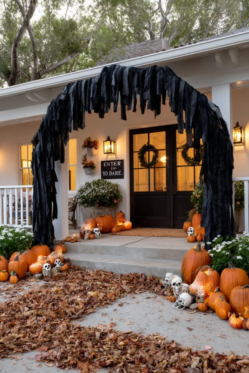 21 Halloween Porch Decorations: Ideas For A Unique Festive Entryway 73 “enter if you dare” archway with black draped fabric 1