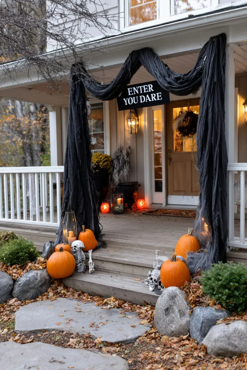21 Halloween Porch Decorations: Ideas For A Unique Festive Entryway 74 “enter if you dare” archway with black draped fabric 1
