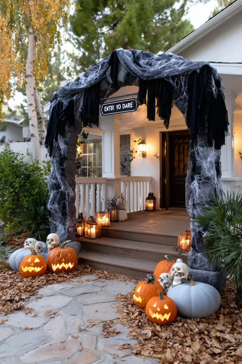 21 Halloween Porch Decorations: Ideas For A Unique Festive Entryway 77 “enter if you dare” archway with black draped fabric 1