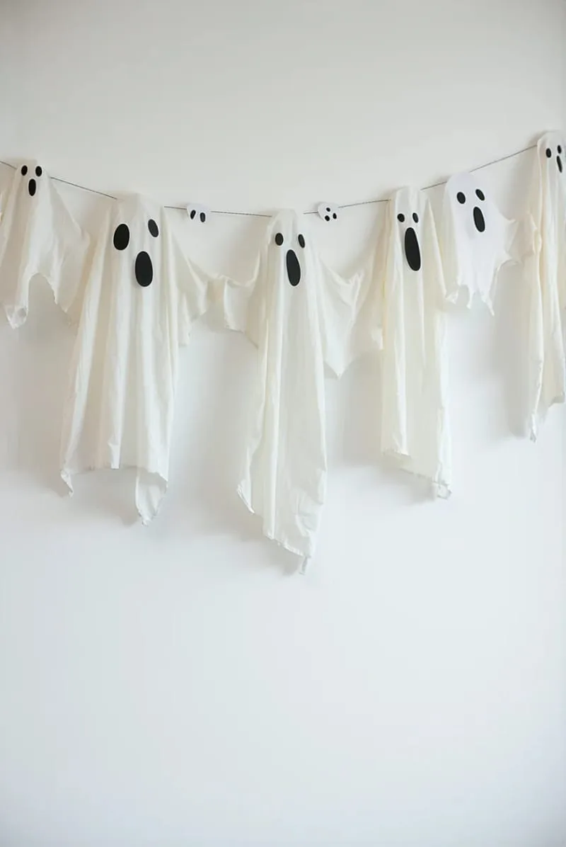 floating ghost garland made from white fabric and black marker faces 1