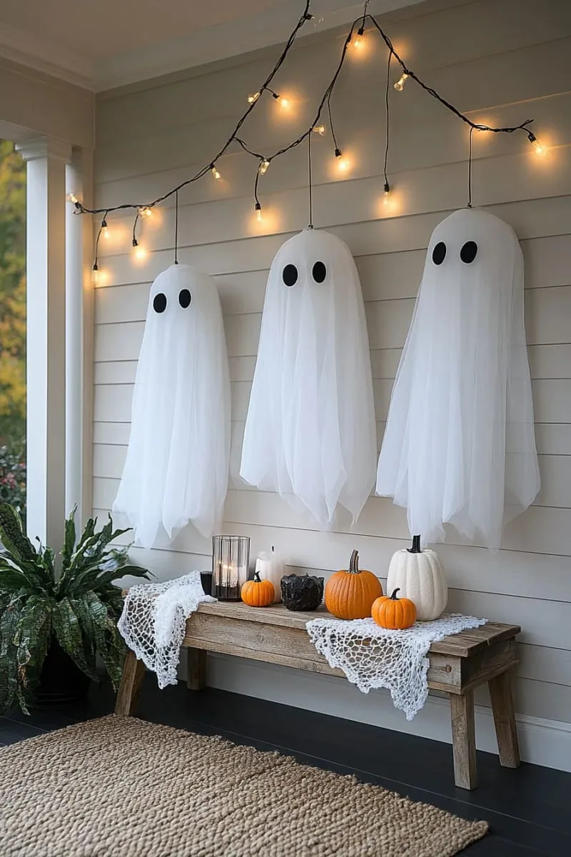 21 Elegant Indoor Halloween Decor Ideas for Modern Spaces 39 ghost silhouettes dangling from ceiling with twinkle lights. 1