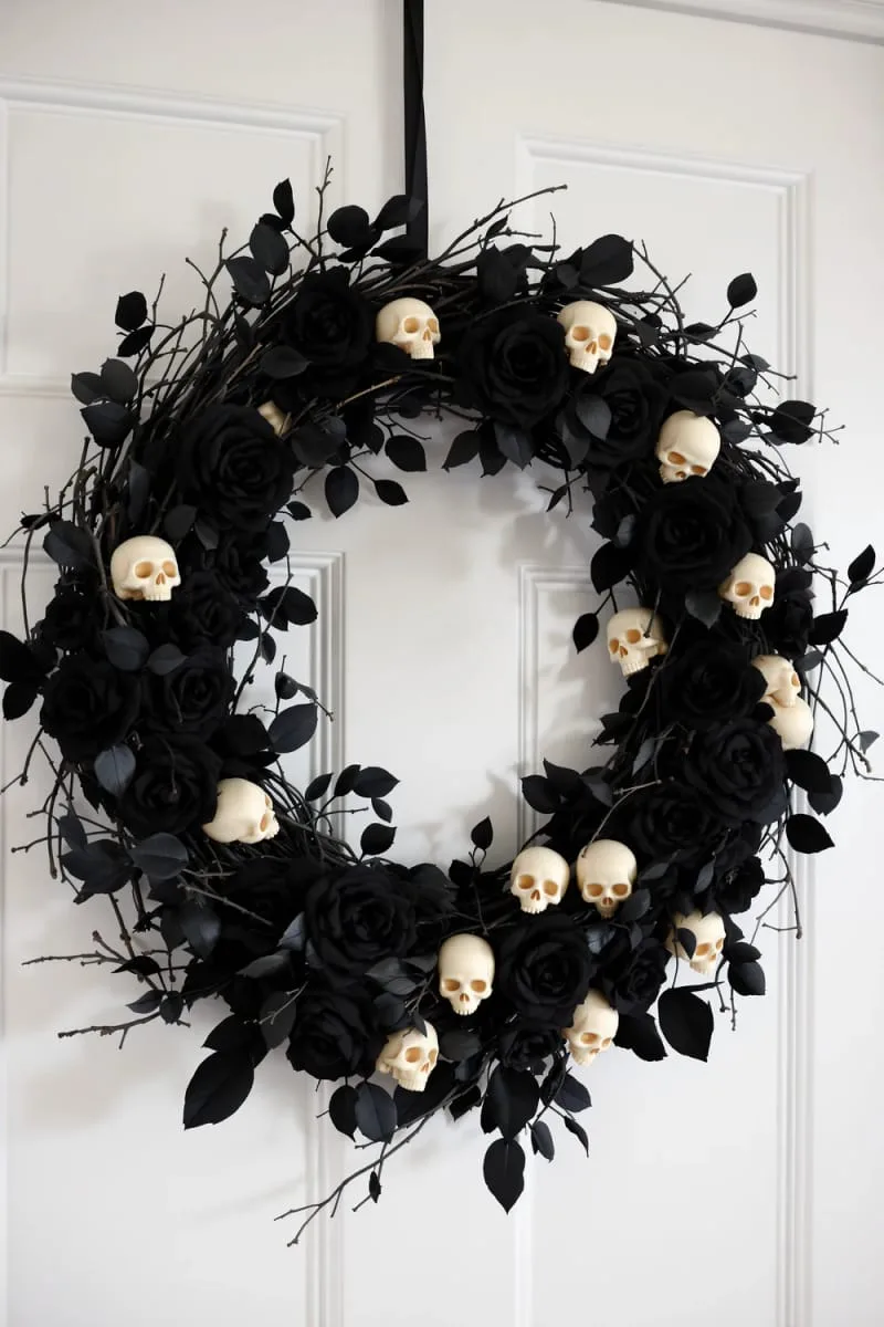 halloween wreath with faux black roses and tiny plastic skulls 1