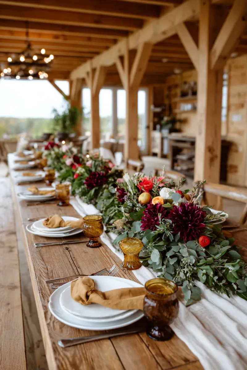 orange and burgundy floral arrangements with eucalyptus sprigs 1