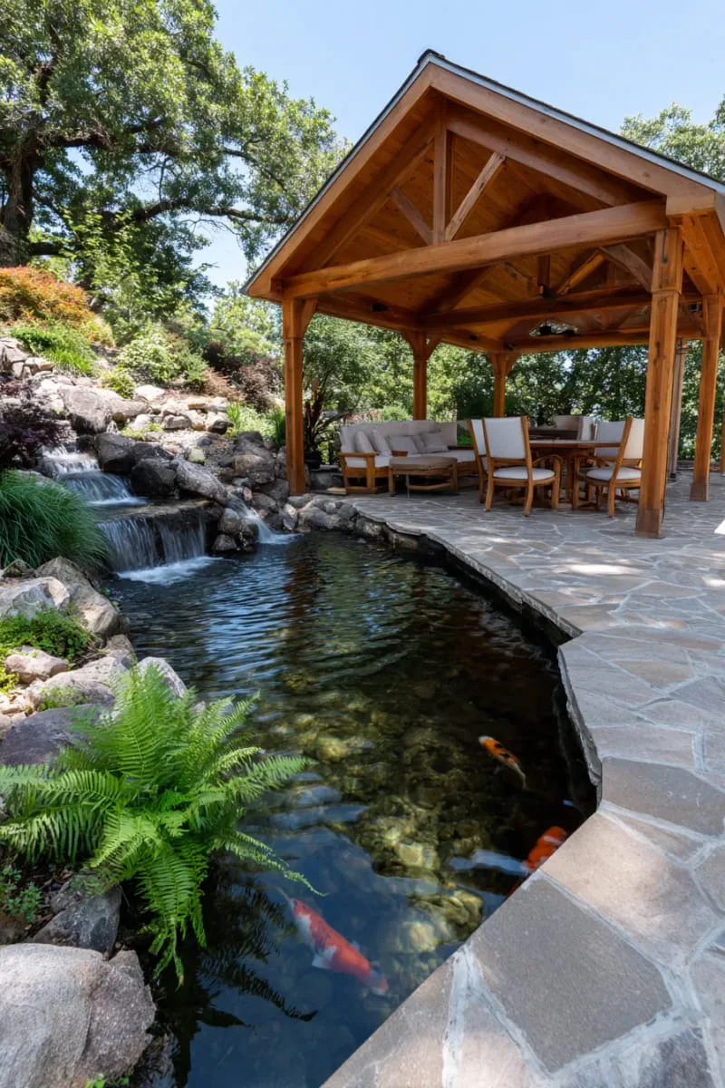 19 Inspiring Backyard Pavilion Ideas: Unique Designs You Can't Miss 24 pavilion with cascading waterfall feature and koi pond nearby 1