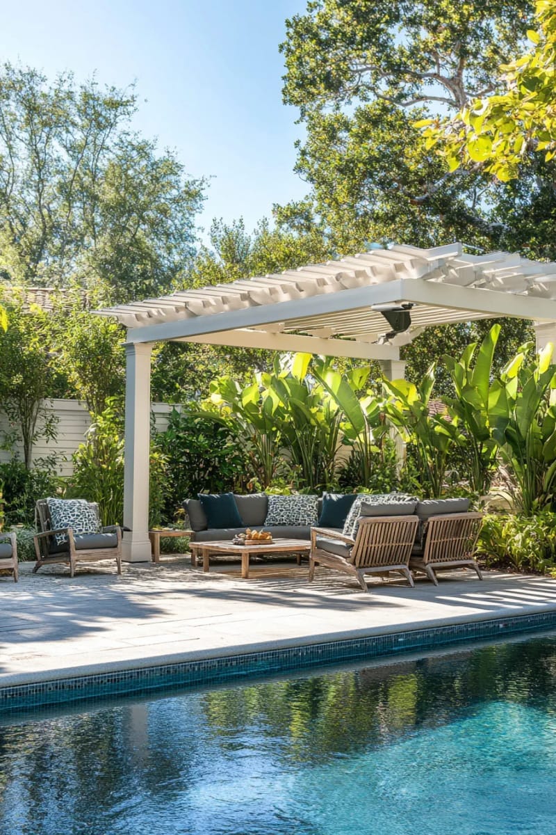 poolside pergola featuring retractable canopy and tropical plants 1