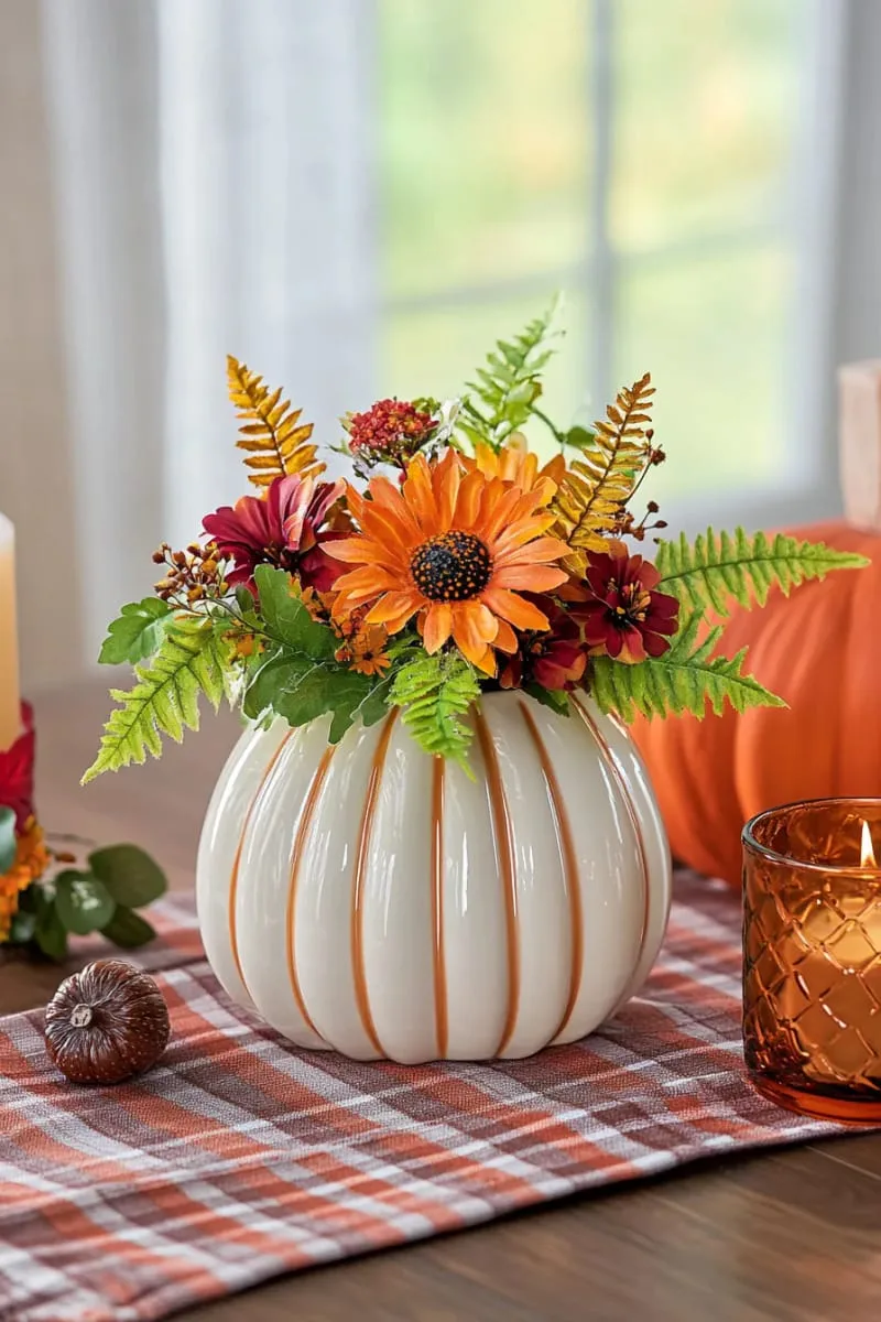 pumpkin-shaped ceramic vases filled with wildflowers and ferns 1