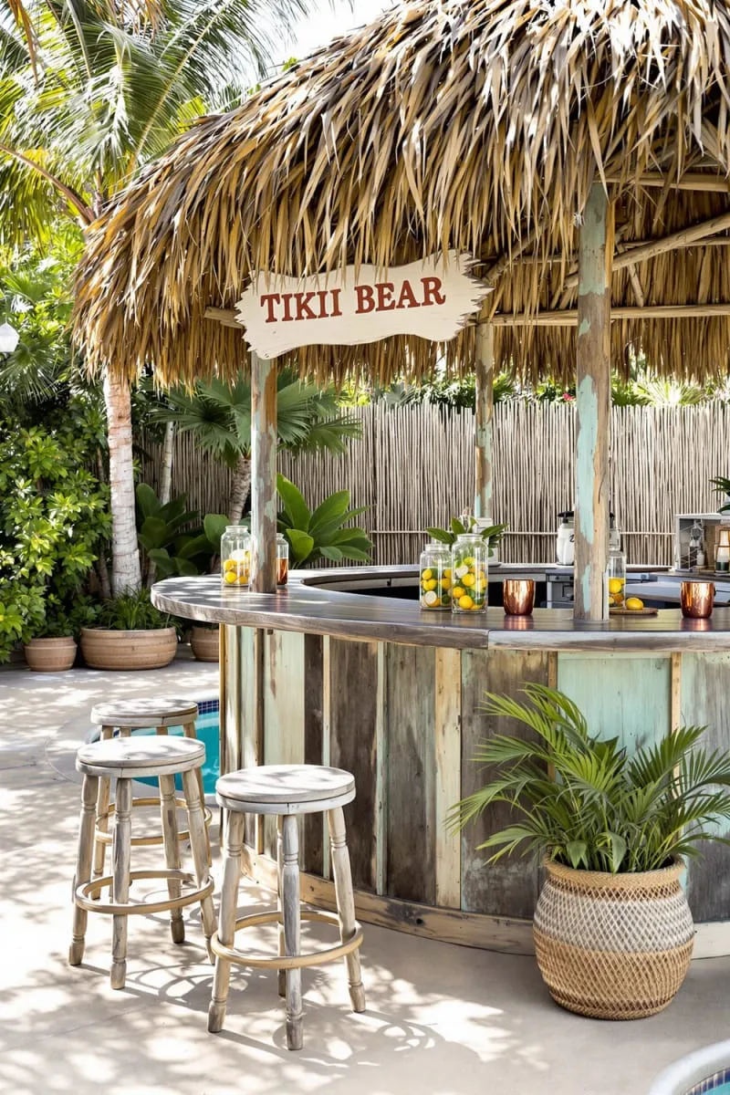 rustic tiki bar with straw roof beside the pool’s edge 1
