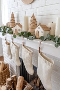 scandinavian-inspired mantel with neutral decor and wooden trees 39
