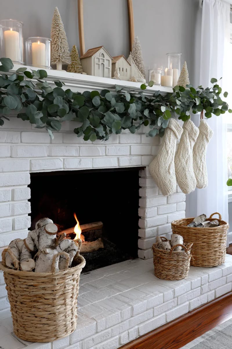 scandinavian-inspired mantel with neutral decor and wooden trees 1