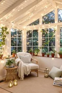19 Small Sunroom Ideas to Brighten Small Spaces 1 string fairy lights across ceiling beams for magical evening ambience 4