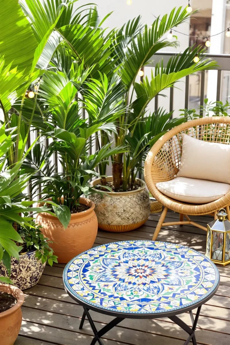 tiled mosaic coffee table and lush potted palms 1