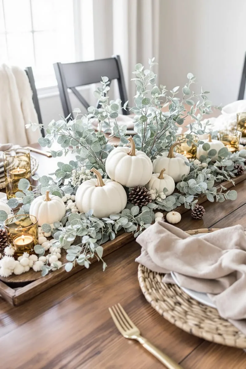 white pumpkin ornaments paired with frosted eucalyptus stems 1
