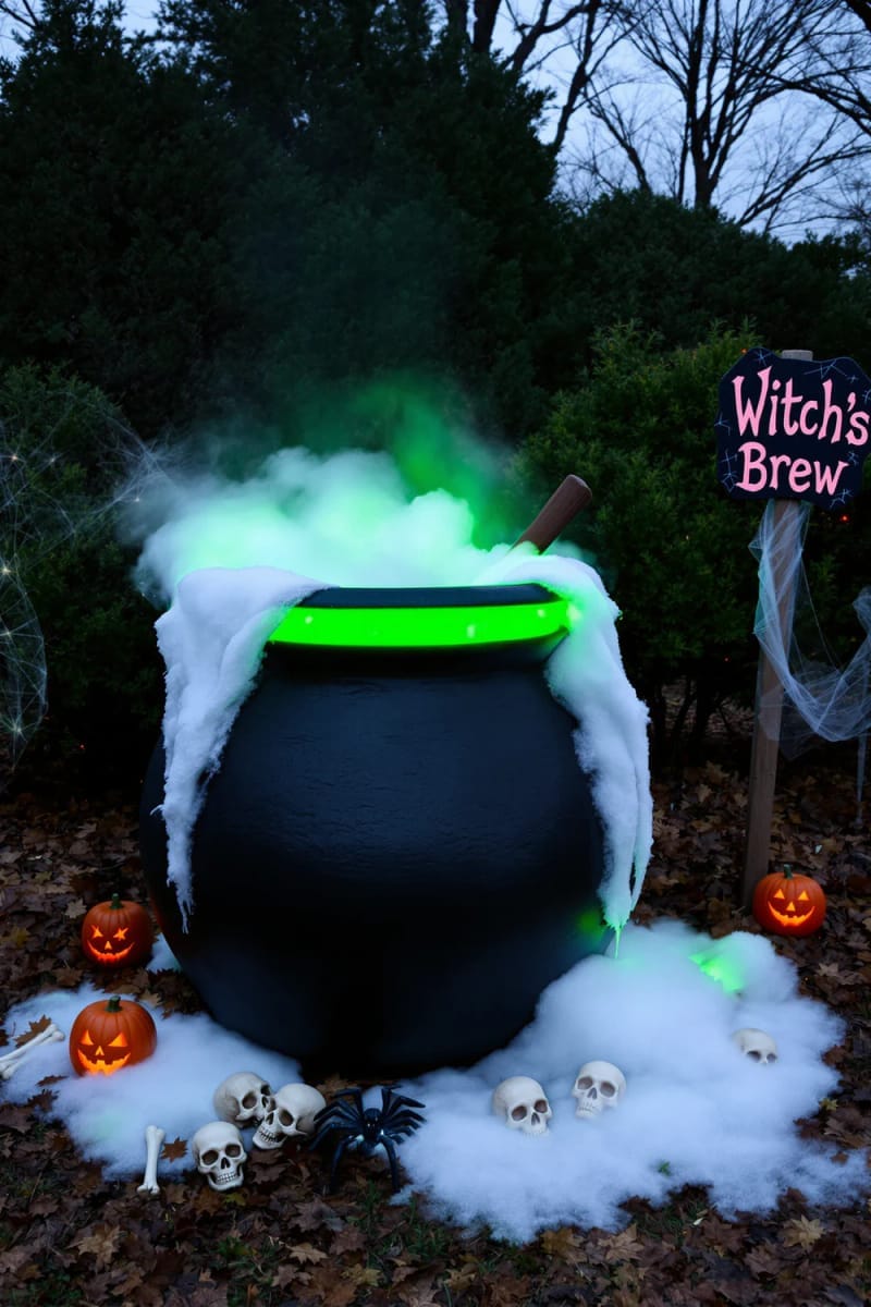 21 Unique Outdoor Halloween Decorations to Try This Year 32 witch’s cauldron bubbling with green lights and dry ice 1