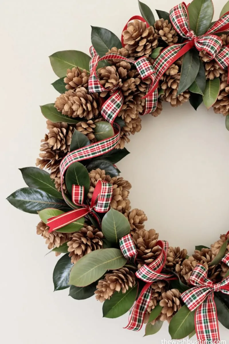 wreath of pinecones and magnolia leaves with plaid accents 1