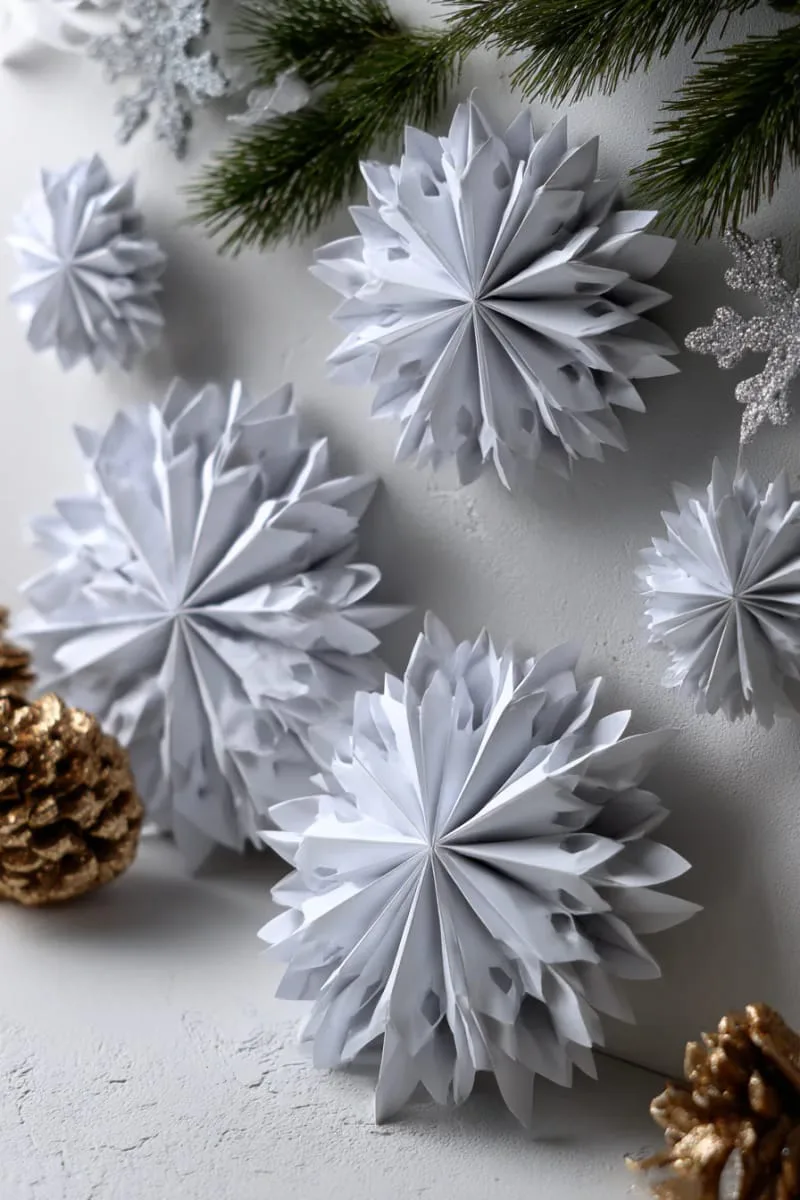 3d paper snowflakes in minimalist white folded geometric shapes 1