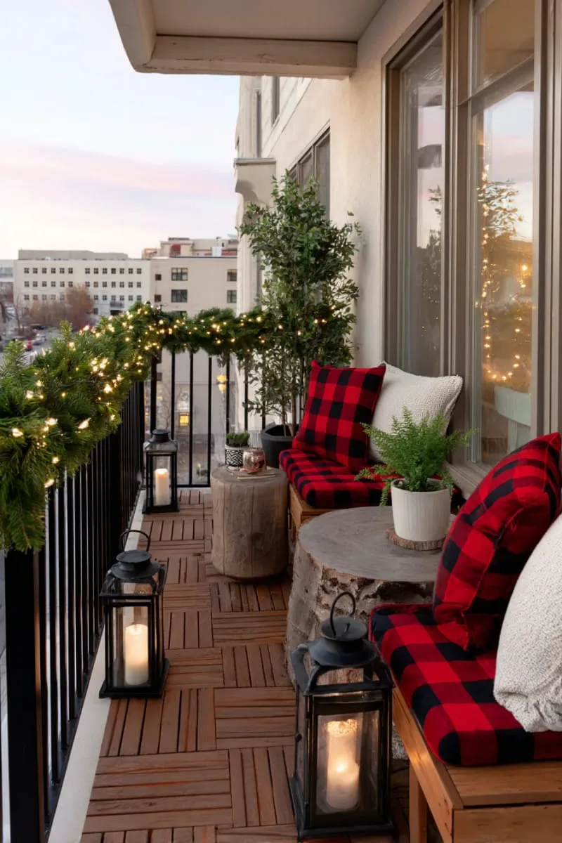 apartment balcony lined with garland, lanterns, and plaid cushions 1