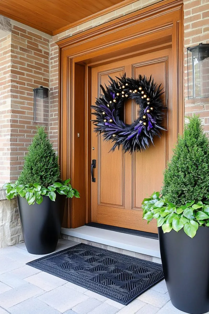black feather wreath with subtle gold beads for a dramatic door display 1
