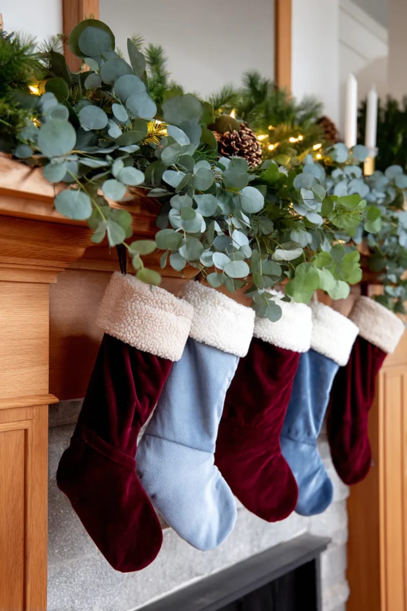 29 Stylish Christmas Mantle Decor Ideas to Inspire Your Home 10 burgundy and baby blue stockings paired with lush eucalyptus garland 1