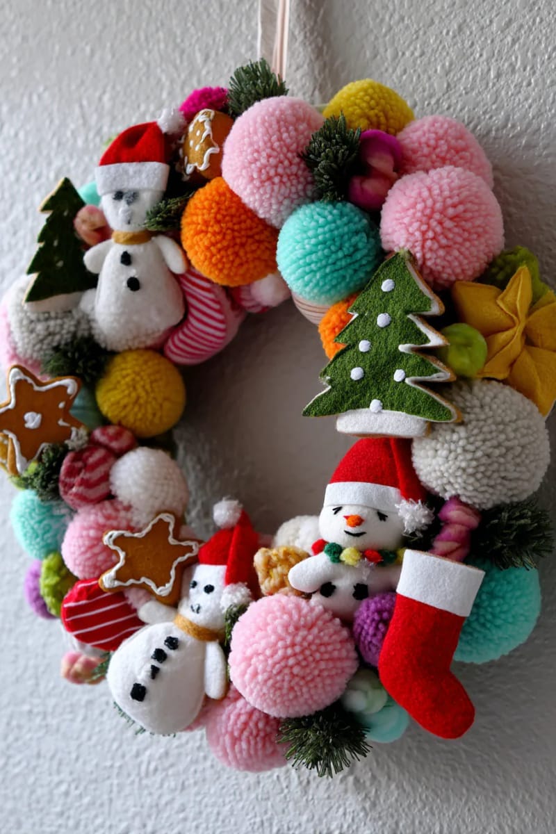23 Kitsch Christmas Decor Ideas Full of Color, Whimsy, and Cheer 27 candy-colored pom-pom wreath with tacky felt christmas shapes 1