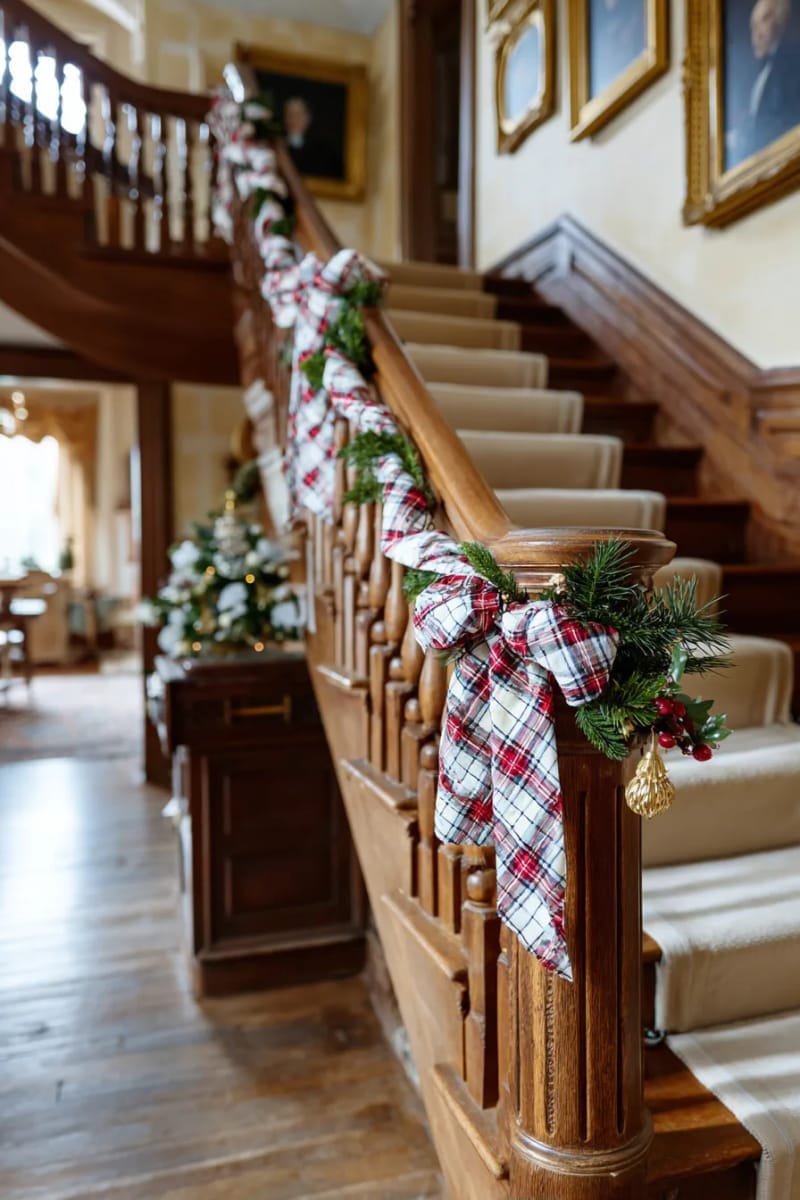 27 Vintage Christmas Decorations You'll Love 50 classic tartan ribbons wrapped around staircase banisters and framed portraits 1