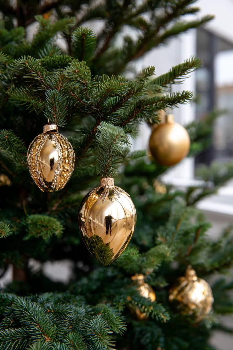 elegant gold ornaments nestled in lush evergreen arrangements 1