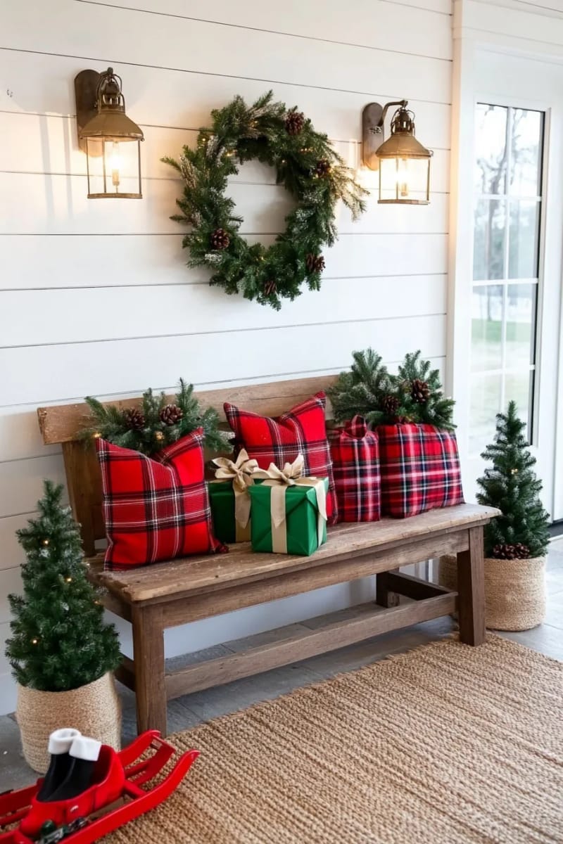 festive entryway bench with plaid pillows, wrapped gifts, and mini pine trees 1