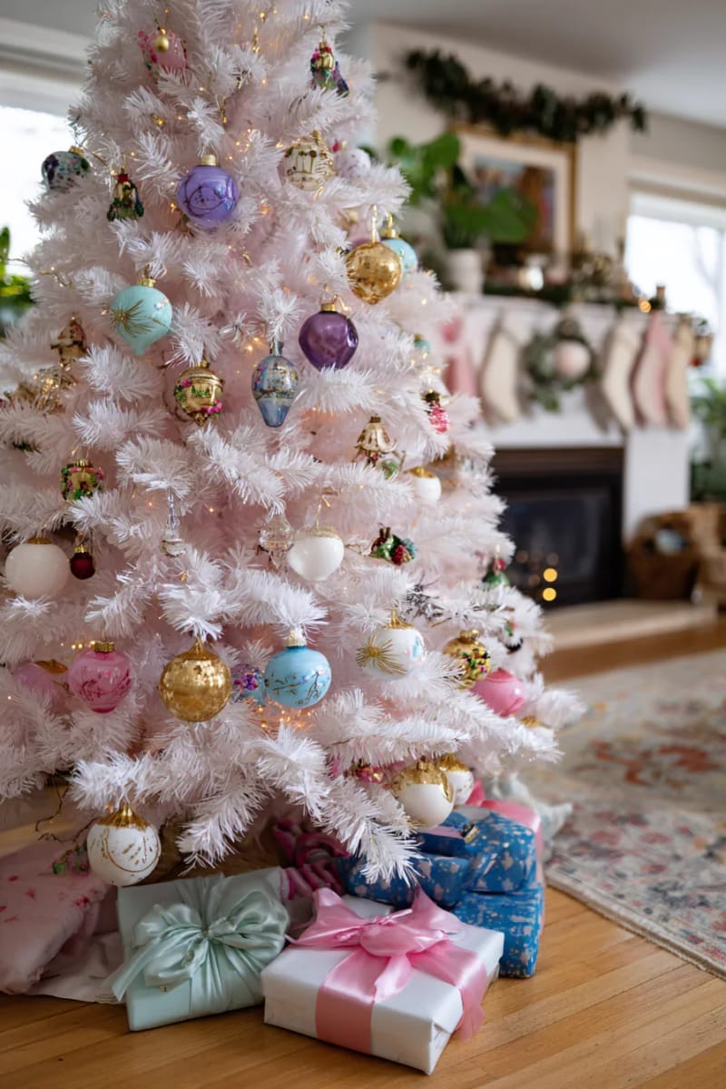 23 Kitsch Christmas Decor Ideas Full of Color, Whimsy, and Cheer 3 flocked pastel pink christmas tree overflowing with vintage glass ornaments 1