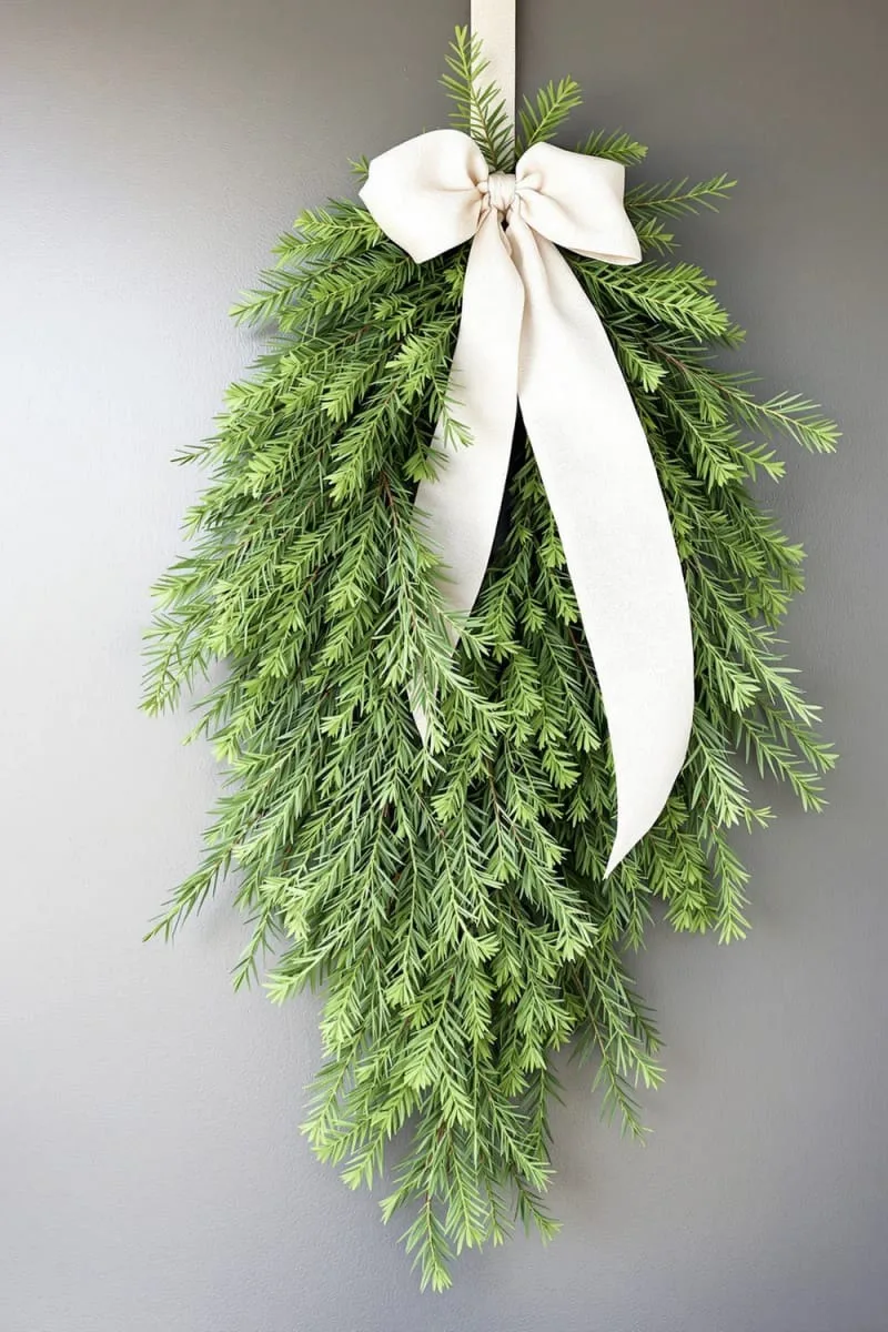 fresh cedar swag tied with neutral linen ribbon for your front door 1