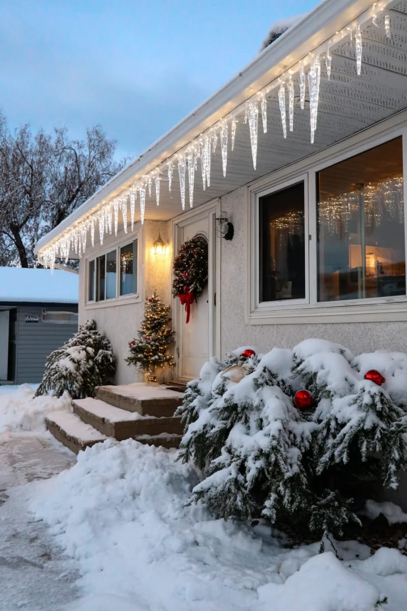 frosted icicle lights cascading from rooftop and window frames 1