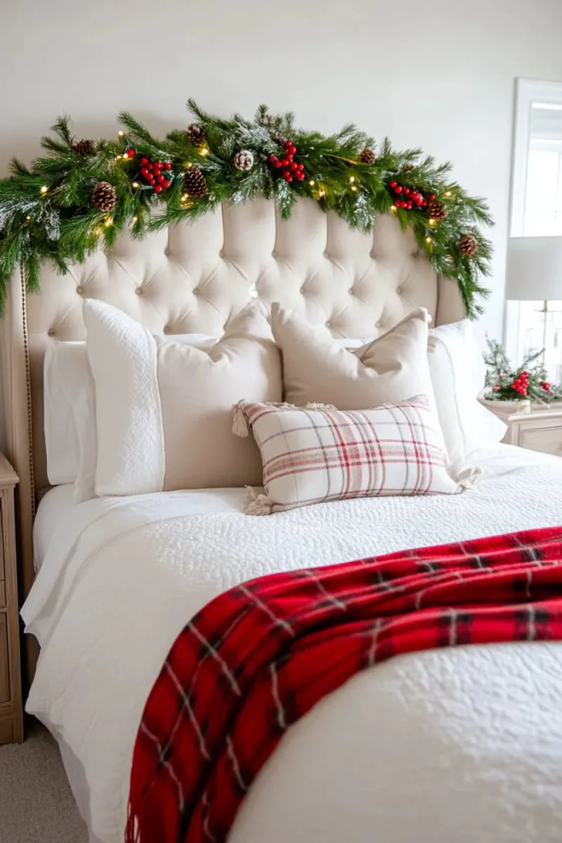 garland draped above the headboard with red berries and pinecones 1