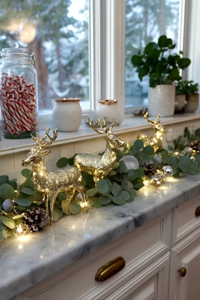 23 Christmas Countertop Decor Ideas Guests Can’t Stop Talking About 59 glittering gold reindeer figurines nestled among eucalyptus branches 1