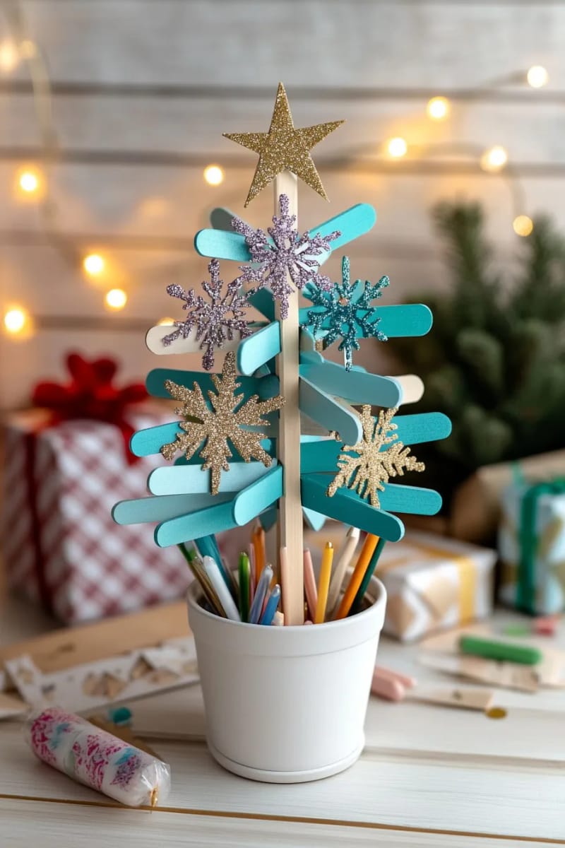 23 Kids Christmas Tree Ideas Full of Color, Whimsy, and Holiday Cheer 44 glittery snowflake and star ornaments made from popsicle sticks on a mini tree 1