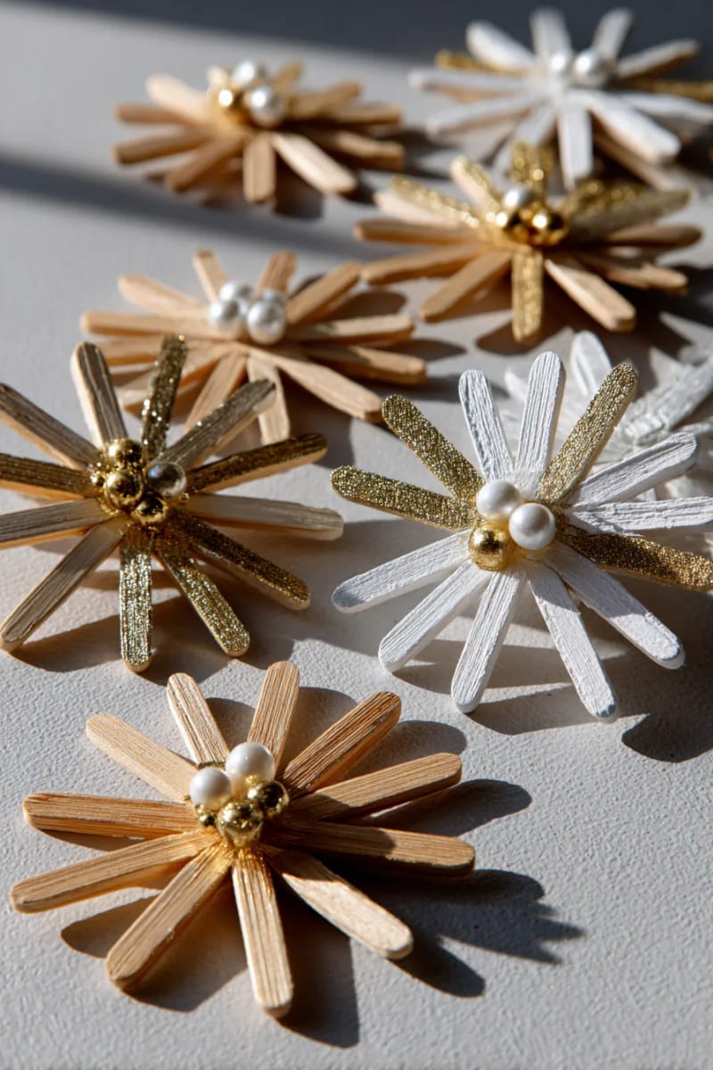 27 Unique Christmas Craft Decorations for Inspired Homes 100 gold and white starburst ornaments made from popsicle sticks 1
