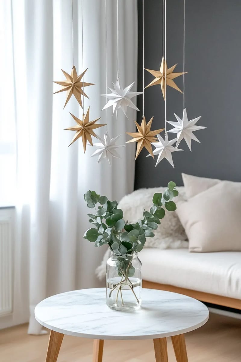 25 Best Christmas Window Decor Ideas to Try This Year 34 hanging 3d origami stars in metallic gold and white for modern elegance. 1