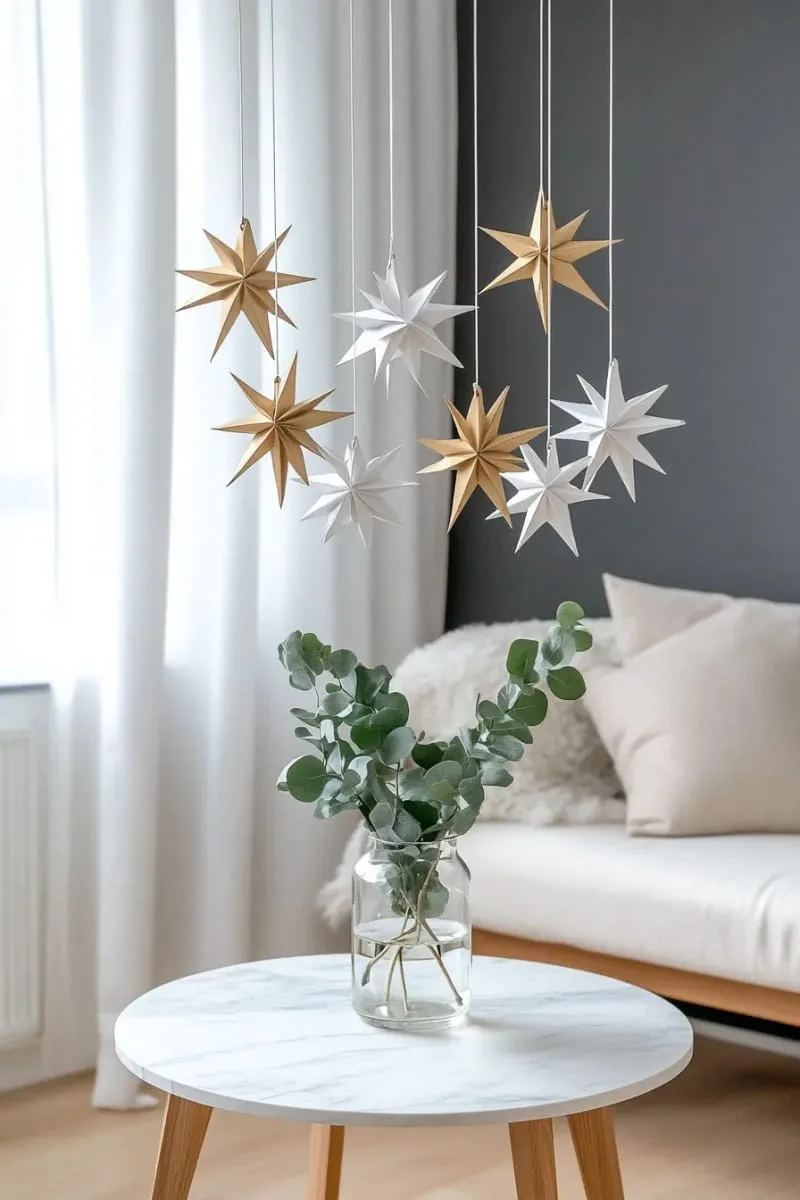 25 Best Christmas Window Decor Ideas to Try This Year 62 hanging 3d origami stars in metallic gold and white for modern elegance. 1