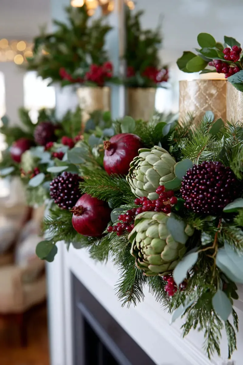 29 Best Christmas Decorations Trends You Can't Miss This Year 113 lush garland with pomegranates and artichokes for a nature-inspired mantel 1