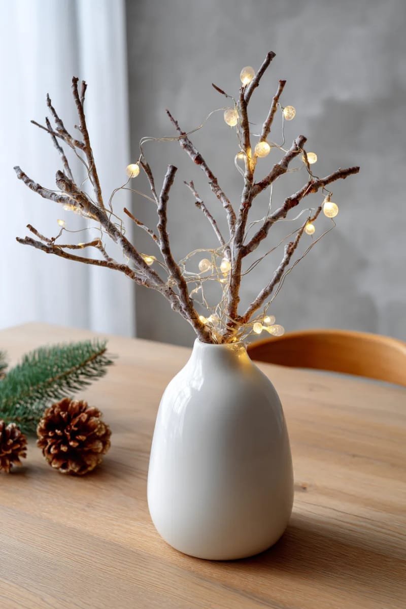 25 Gorgeous Winter Decor Ideas (Not Christmas) for a Serene Home 30 minimalist branch arrangement in ceramic vase with fairy lights 1
