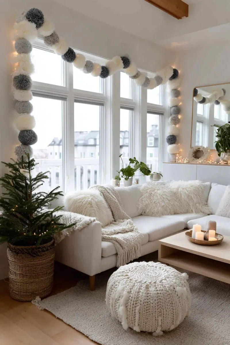 neutral wool felt ball garland draped across windows or mirrors 1